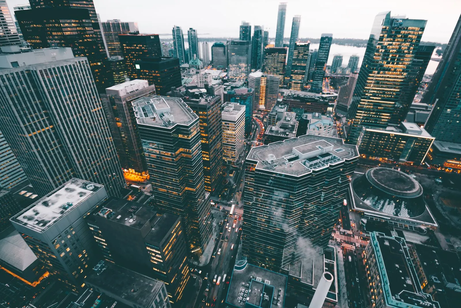 A dense city skyline beneath a bright afternoon sky