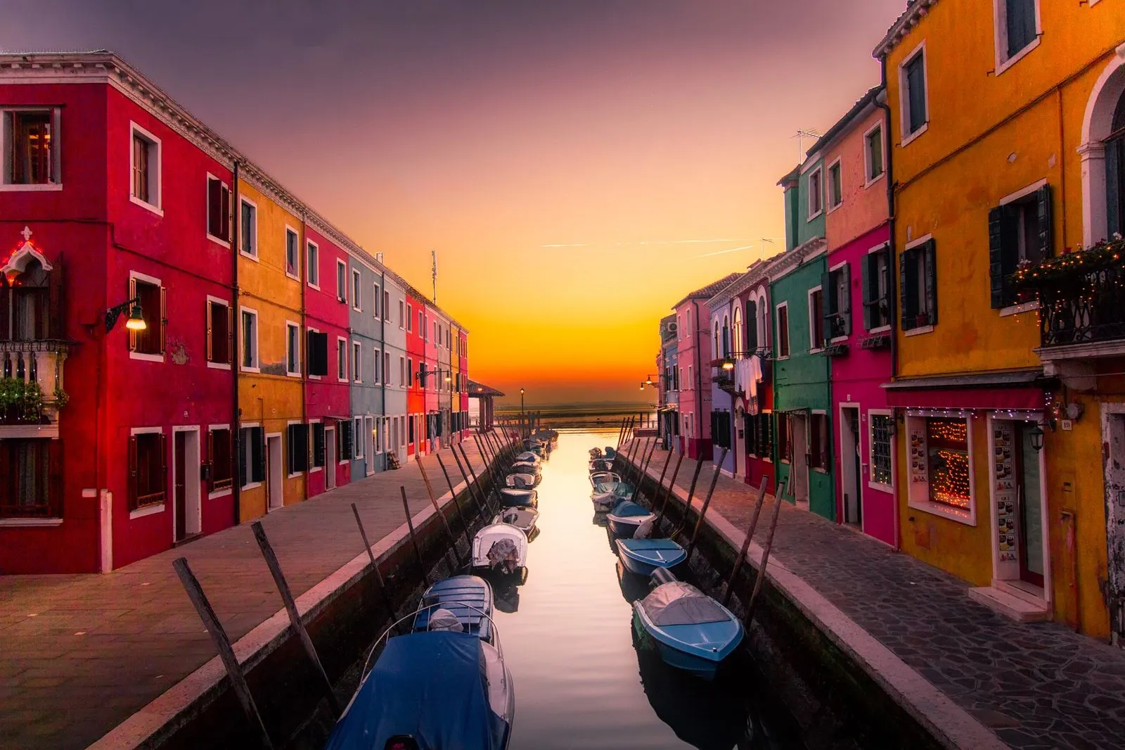 Colorful canal-side buildings at sunset
