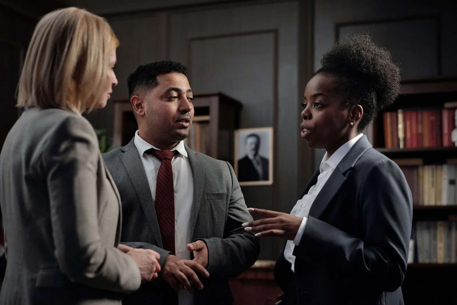 Business colleagues talking in a hallway before a meeting